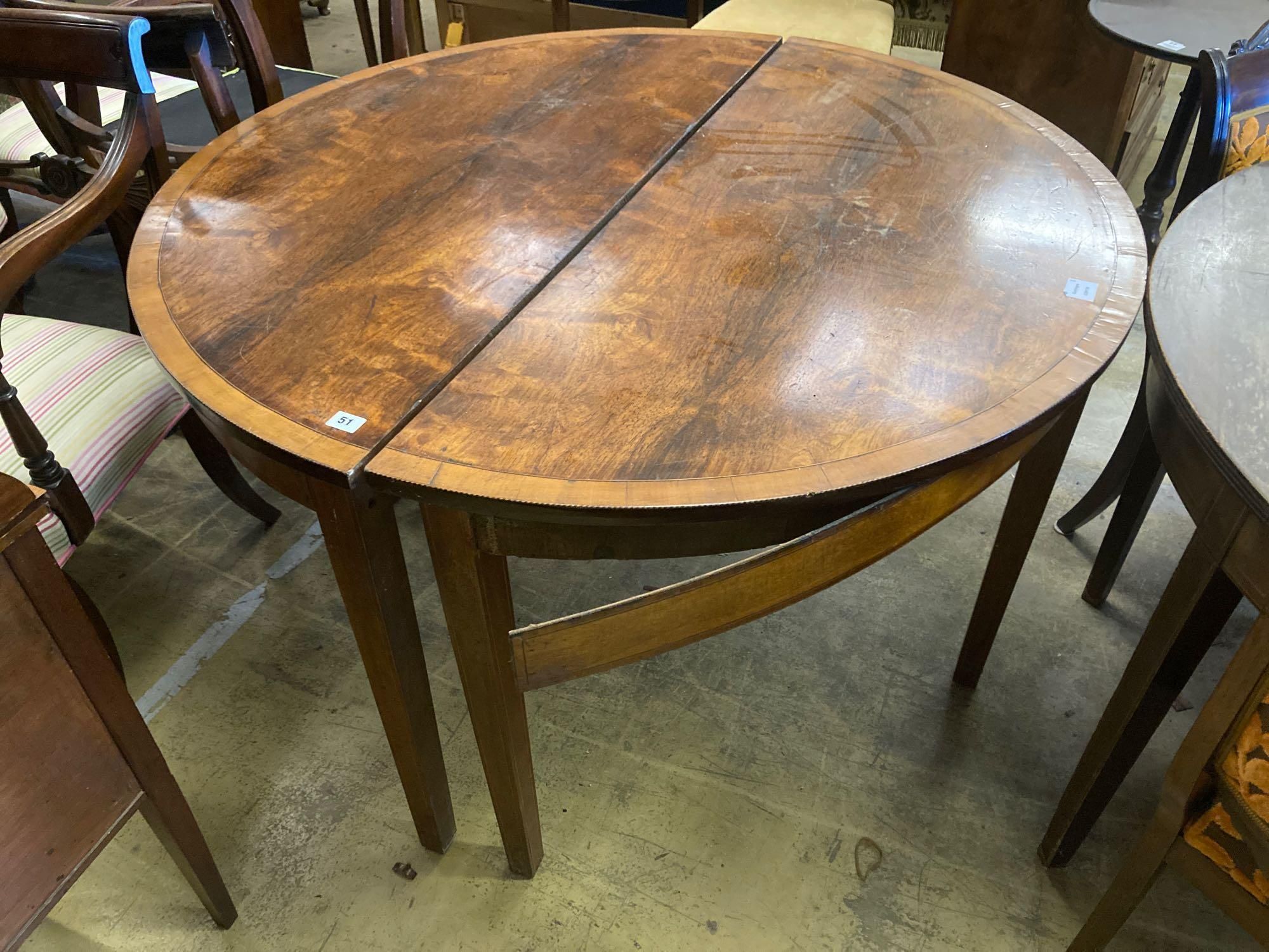 A pair of George III satinwood banded mahogany demi lune dining table ends, width 123cm height 74cm